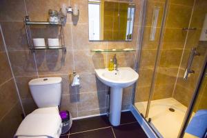 een badkamer met een toilet, een wastafel en een douche bij Eastbourne Reymar in Eastbourne
