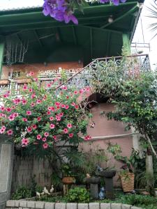 a bunch of flowers hanging from a building at Taichung Xinshe Garden Life Homestay B&B in Xinshe