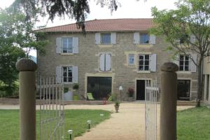 a house with a fence in front of it at Les terres in Chaponost