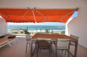 a dining room with a table and a view of the ocean at Las Vistas Sunset Sea View in Arona