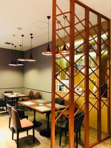 ein Esszimmer mit Holztischen und Stühlen in der Unterkunft Borrman International Hotel Canton Tower Chigang Metro Station Flagship Branch in Guangzhou