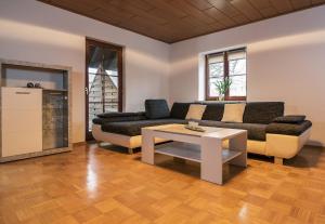 a living room with a couch and a table at Ferienwohnung am Bodensee Heiligenberg in Heiligenberg