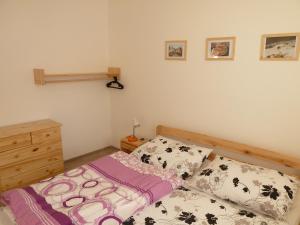 a small bedroom with a bed and a dresser at Apartmány pod Kraličákem in Dolní Morava