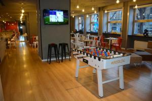 a room with a foosball table in a restaurant at Allegroitalia Espresso Darsena in Milan