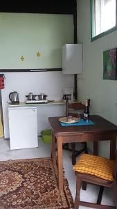 a kitchen with a wooden table and a counter top at shepherds cottage in Euscheid