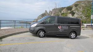 a van parked in a parking lot near the ocean at Borgo di Santa Barbara in Santa Domenica