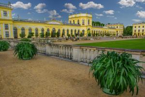 a large yellow building with plants in front of it at Hotel zum Schiffchen in Wolfhagen