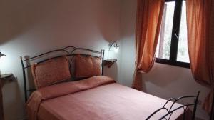 a bedroom with a bed and a window at Appartamenti Sardegna in Porto San Paolo
