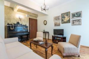 a living room with a couch and a tv at Pierre Marie Corfu Old Town Home in Corfu Town