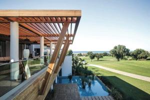 an external view of a house with a swimming pool at Bahia Golf Beach-Odyssée-Appartement in Bouznika