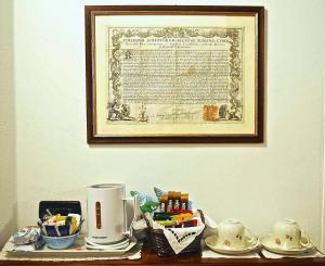 a table with a coffee maker and a picture on the wall at Il Giardino Incantato in Monterosso al Mare