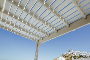 a pergola with awning on top of a building with a city at Viva Mare Studios in Astypalaia Town