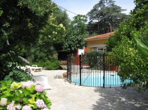 a gate in front of a house with flowers at Plage de Saint Clair à 50m in Le Lavandou
