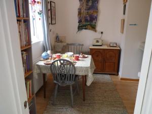 a dining room table with two chairs and a table with at The Farthings in Braunton