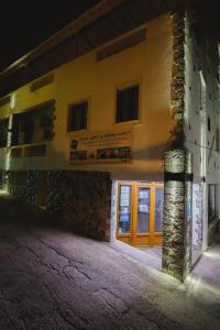 a building at night with the front door open at Viva Mare Studios in Astypalaia