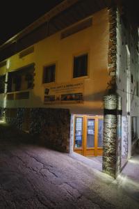 a building at night with the front door open at Viva Mare Studios in Astypalaia Town