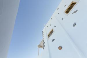 a group of flags on the side of a building at Viva Mare Studios in Astypalaia Town