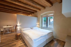 A bed or beds in a room at Albola Suite Holiday Apartments