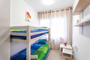 a bunk bed in a small room with a desk at Maison Lamic 2 in Lloret de Mar