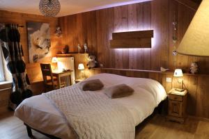 a bedroom with a bed with two pillows on it at Auberge Lorraine in Le Valtin