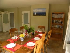 a dining room with a wooden table and chairs at Orchard lodge Bantry in Glanbannoo Upper