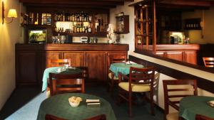 a restaurant with two tables and a bar at Hotel Centro in San José de Mayo