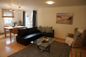 a living room with a black couch and a table at KAntryside in Karlsruhe