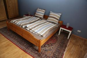 a bed with two pillows on top of a rug at KAntryside in Karlsruhe
