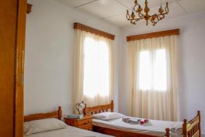 A bed or beds in a room at Pelagion II Sea Coral - Beachfront holiday home