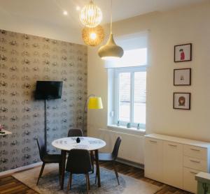 a dining room with a table and chairs and a window at STUDIO 18 in Sopron