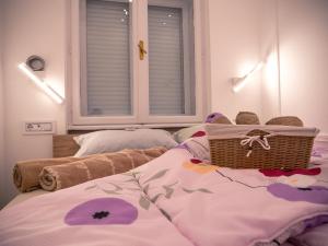 a bedroom with a bed with a basket on it at Centrally Located Relaxing Place in Belgrade