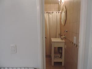 a bathroom with a sink and a shower curtain at Puerto de Lilas in Las Gaviotas +18 photos