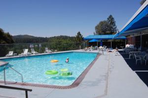 a swimming pool with a frisbee and people in it at Yosemite is Calling in Groveland