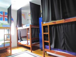 a group of bunk beds in a room at Vila Rock Hostel - próximo Allianz Parque, Vila Madalena, Av Paulista, Hospital das Clínicas INCOR FMUSP in São Paulo