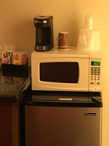 a microwave oven sitting on top of a refrigerator at Canyonlands Motor Inn in Monticello