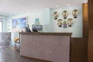 a lobby with a counter and plates on the wall at Saipan Beach Hotel in Saipan