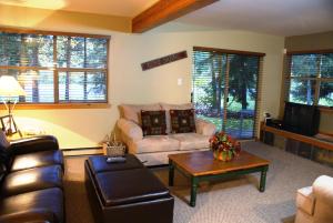 a living room with a couch and a coffee table at Whistler Superior Properties in Whistler