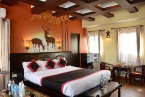a hotel room with a large bed and a large window at Kasthamandap Boutique Hotel in Kathmandu