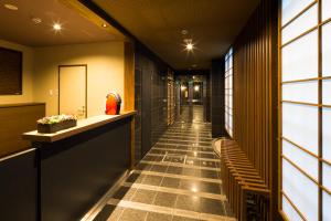 a corridor of a building with a long hallway at Kyoto Riverview House Kyoraku in Kyoto