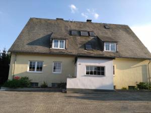 a large yellow and white house with a roof at Heaven in Winterberg