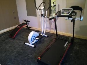 a room with two exercise bikes and a treadmill at Villa Kefali in Kavoúsion