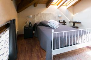 a bedroom with a bed with a white crib at Camere Da Kico in Assago