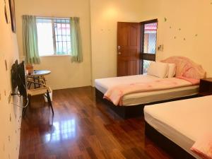 Ліжко або ліжка в номері Chin Shan B&B