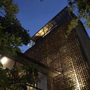 a facade of a building with a metal wall at Inchantreedoopool in Kanchanaburi City