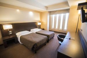 Letto o letti in una camera di E' Hotel
