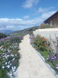 a walkway in a garden with flowers at Terramara in Nohia
