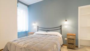 a bedroom with a large bed and a window at Fiori sull'Acqua Apartments in Peschiera del Garda +60 photos