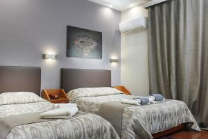 Ένα ή περισσότερα κρεβάτια σε δωμάτιο στο Hotel Lithaion