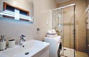 a bathroom with a sink and a toilet and a shower at Dwie Sosny Apartament 38 - Perła in Ustronie Morskie +19 photos