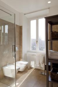 a bathroom with a toilet and a sink and a shower at Parco Sempione in Milan